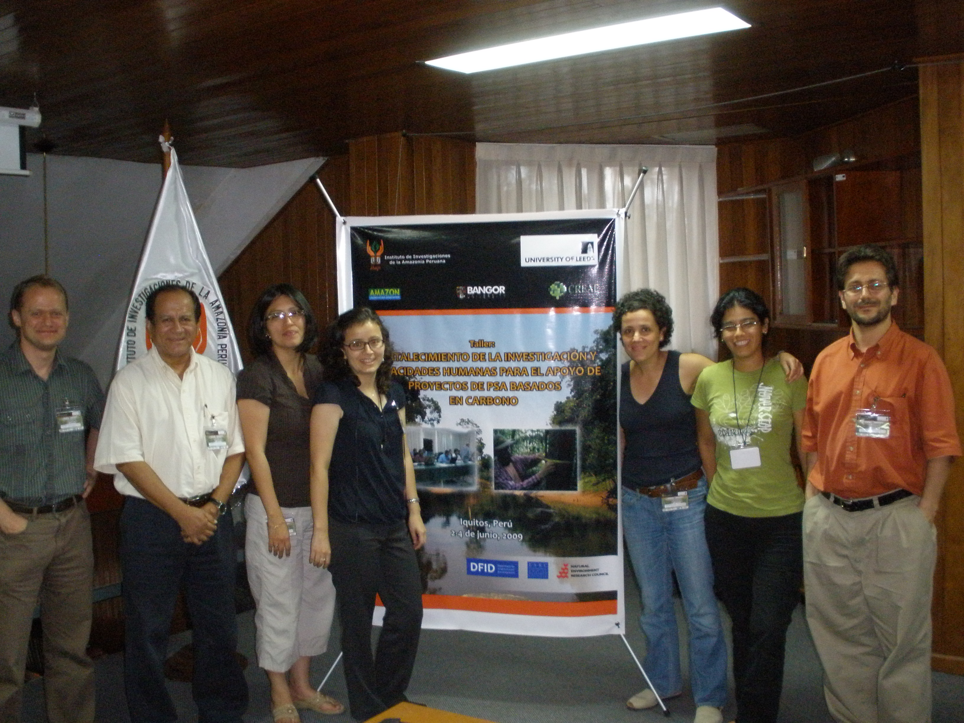 Team members and workshop banner